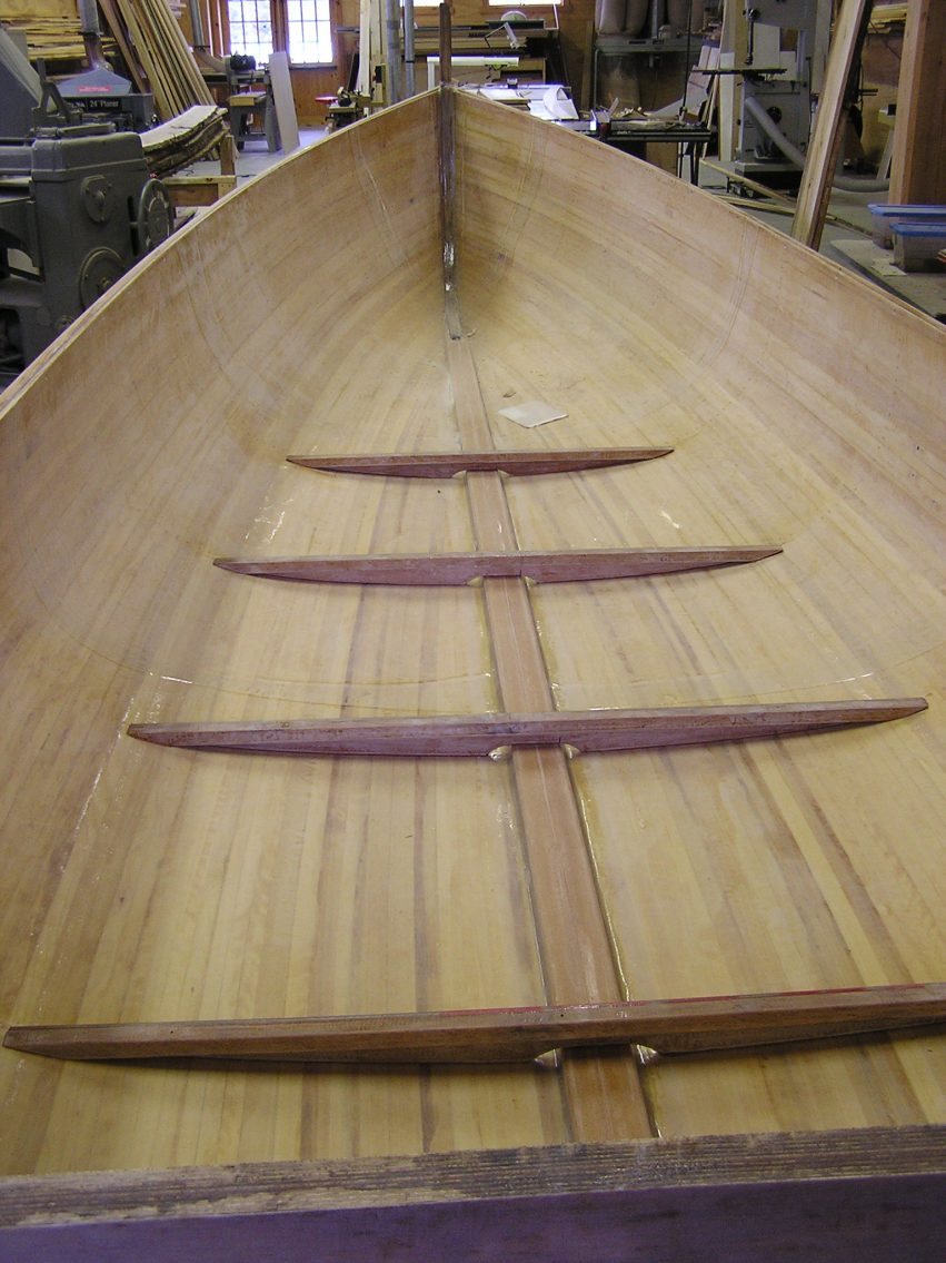 This is a cold molded, cedar stip and glass, vacuum bagged hull that was built at the school and had been sitting for a couple years and not getting much attention – so Andy bought it for himself. He’s in the process of adding floors and interior structure. Eventually, it will have a cuddy cabin and be powered by a 15 – 25 hp outboard engine. Perfect for toolin’ around Les Cheneaux.