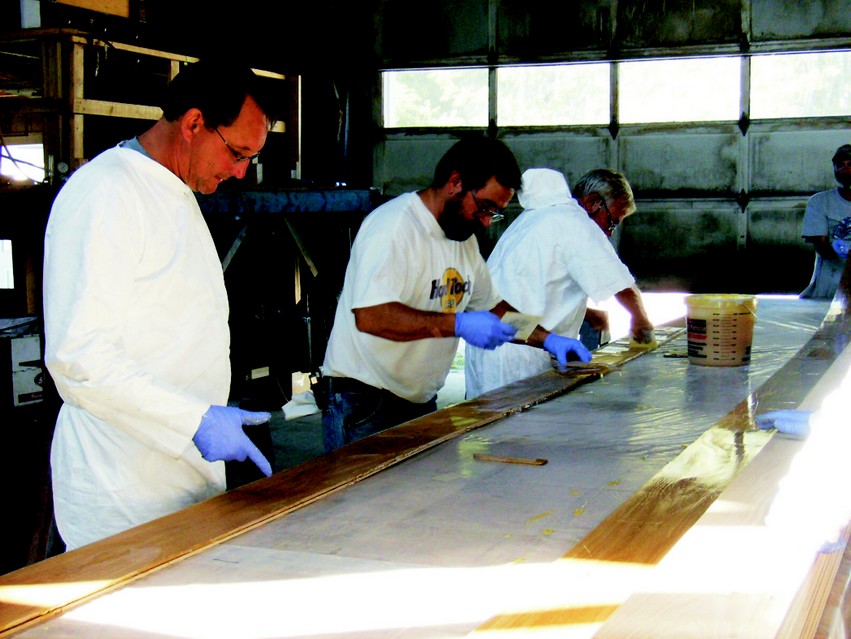 Application of G/Flex 655. A thin coat was squeegeed onto one surface and a thicker coat was applied with notched trowel to the other mating surface in constructing the voyaging canoe.