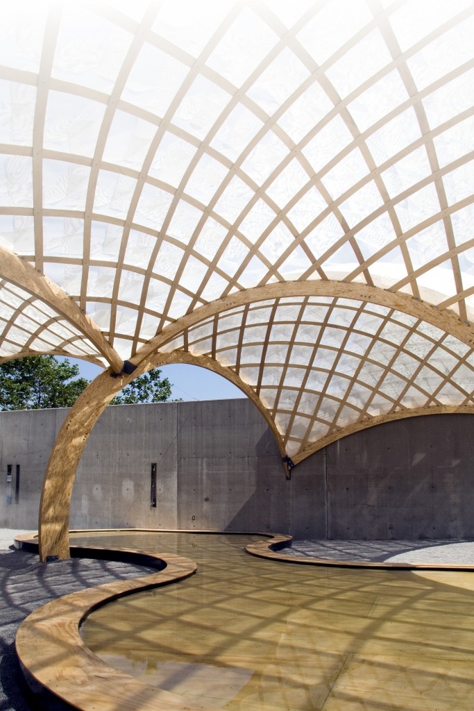 A large, walled triangular outdoor gallery space was partially covered with seven shells and included two shallow tidal pools. The structures and pools were manufactured in a workshop and later deployed on site.