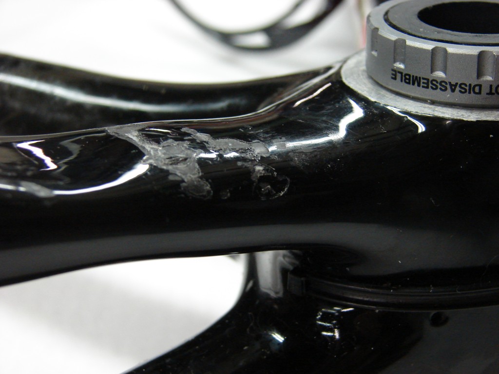 The damage to the carbon fiber bicycle frame.