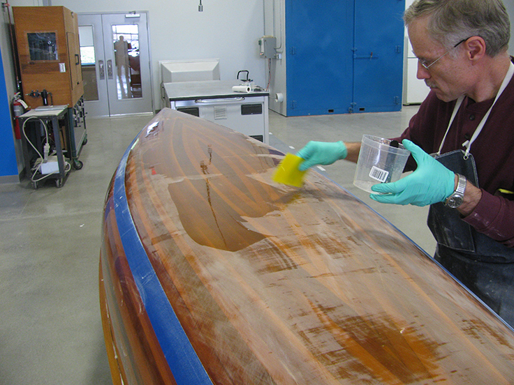 Wood strip canoe: After sanding Tom refills the low spots