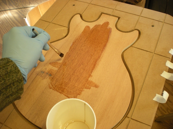 107 being applied to the guitar veneer